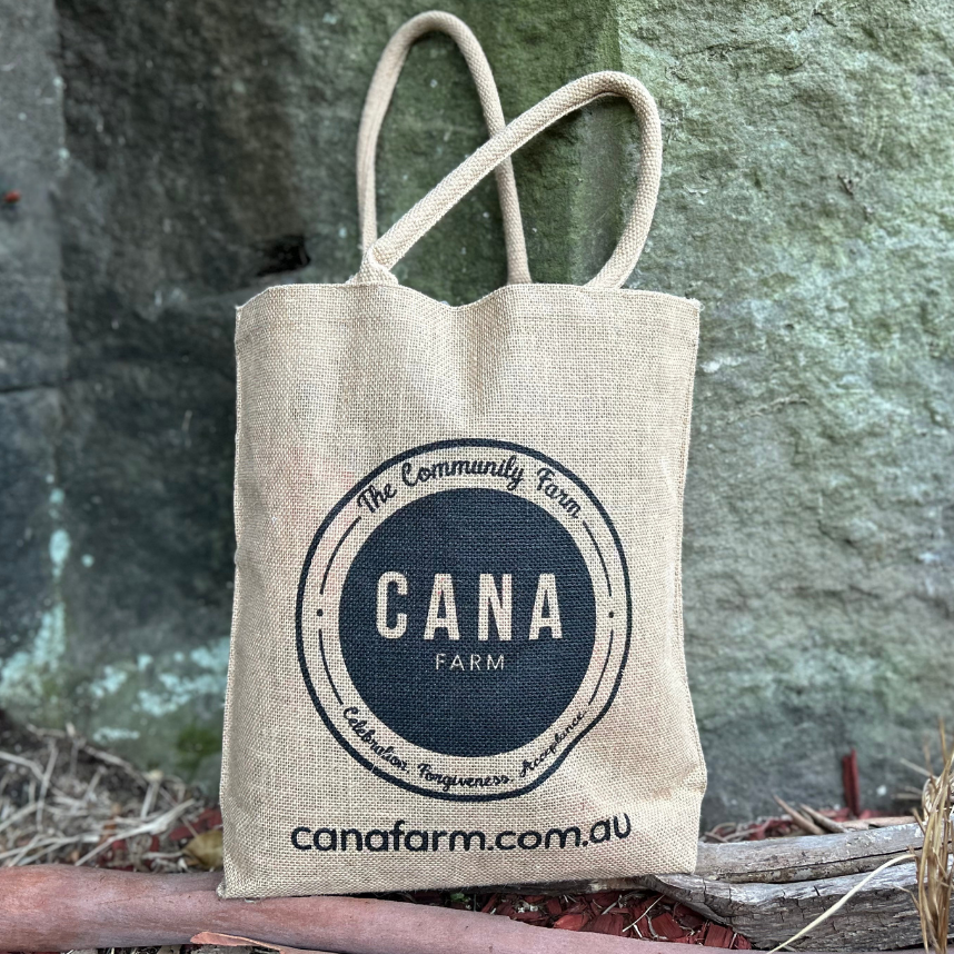 Beige tote bag with 'CANA Farm' logo on a natural background
